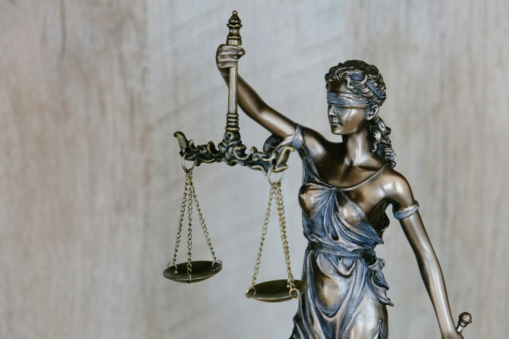 Bronze statue of Lady Justice holding a set of scales