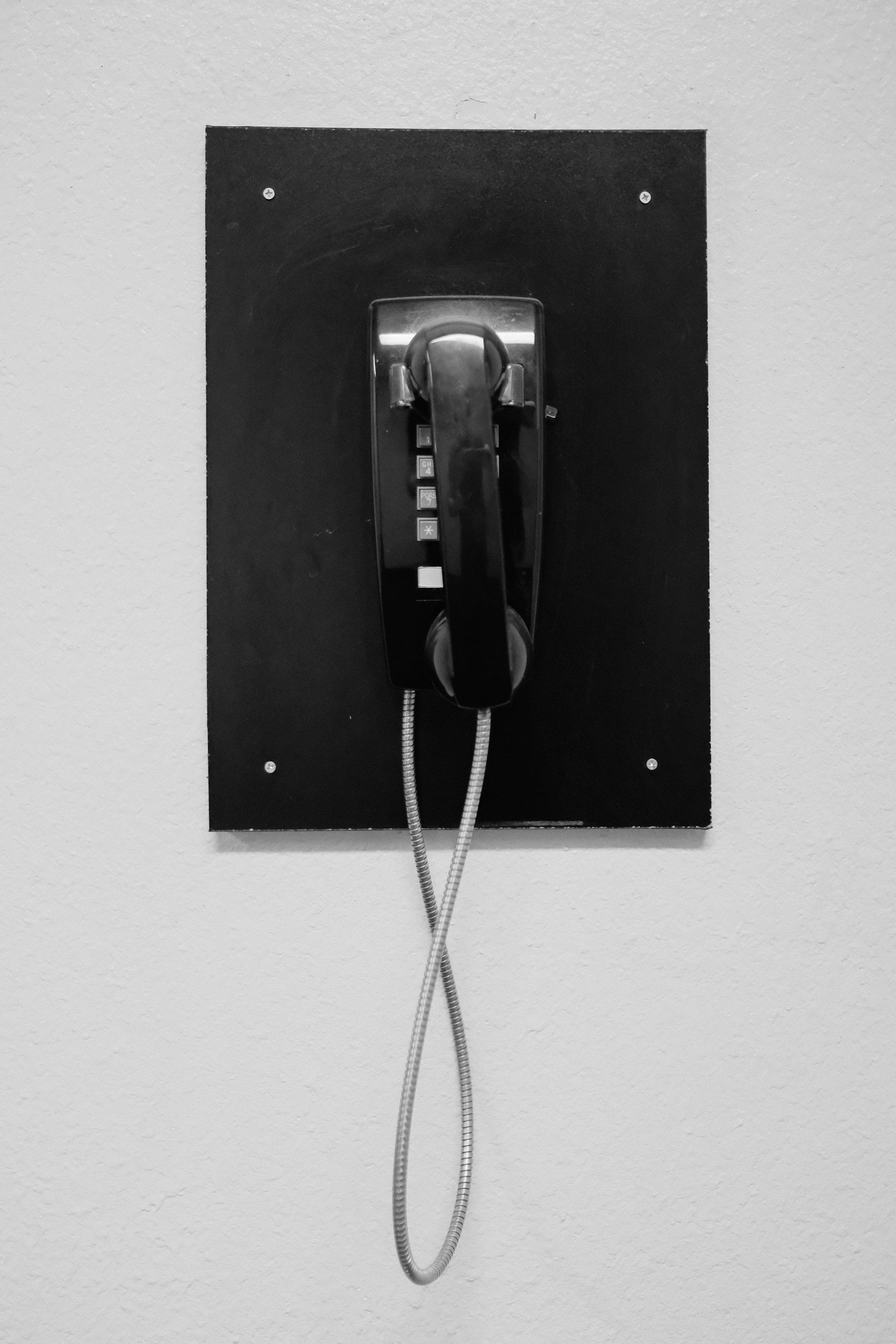 Vintage wall-mounted telephone on a black board